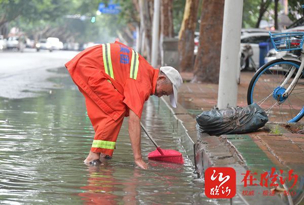 点赞环卫工人冒雨清理积水